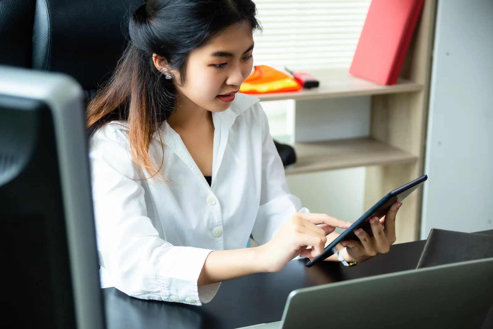 Employee using a tablet at her desk